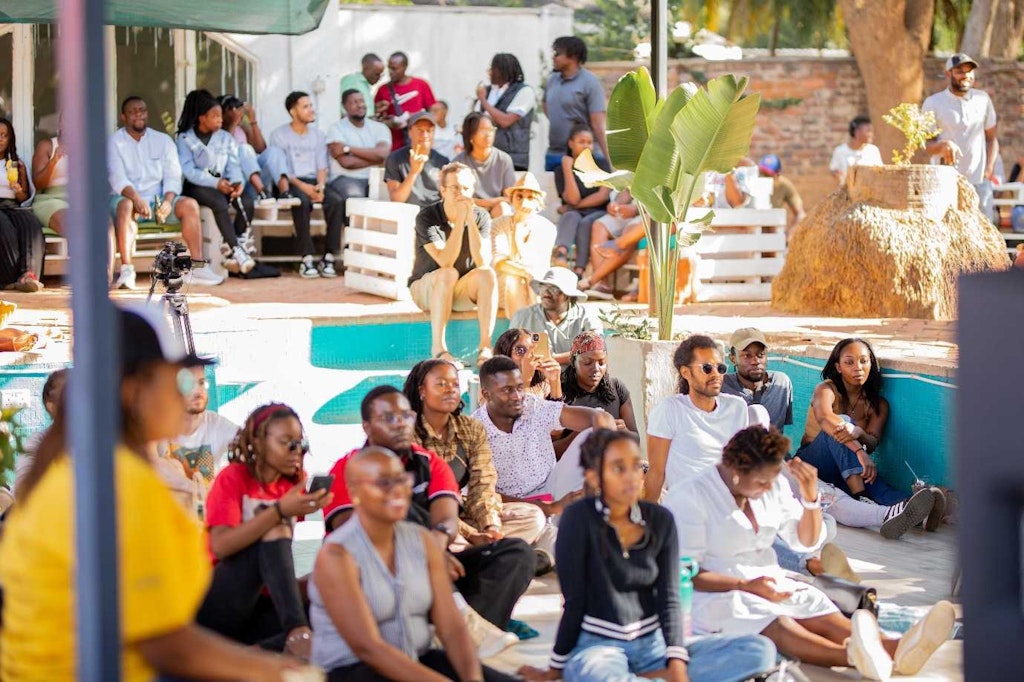 The crowd watches a performance in an empty swimming pool